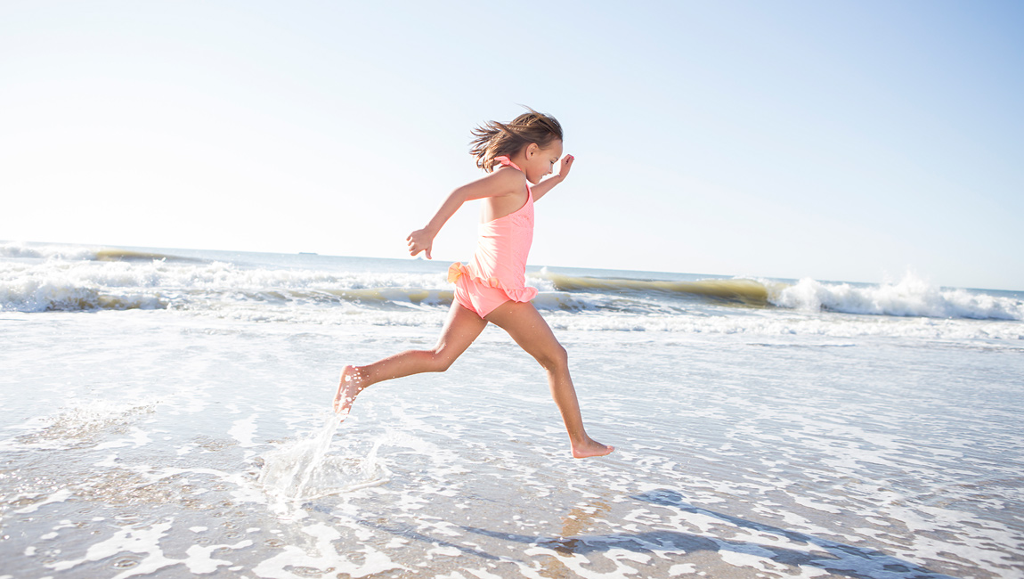 Girl Running On The Beach